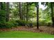 Peaceful backyard setting with chairs, mature trees, and a tranquil, secluded atmosphere at 375 Seewee Cir, Mount Pleasant, SC 29464