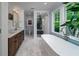 Luxurious bathroom featuring double vanity, free standing tub, glass shower, and window views at 375 Seewee Cir, Mount Pleasant, SC 29464