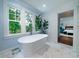 Bathroom with a free standing soaking tub with views to backyard and access to main bedroom at 375 Seewee Cir, Mount Pleasant, SC 29464