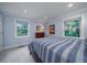 Serene bedroom with light blue walls, comfortable bed, and sunny windows at 375 Seewee Cir, Mount Pleasant, SC 29464