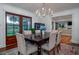 Elegant dining room with wood floors, modern chandelier and access to back porch at 375 Seewee Cir, Mount Pleasant, SC 29464
