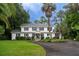 Charming two-story white home with black shutters and a circular driveway surrounded by lush landscaping at 375 Seewee Cir, Mount Pleasant, SC 29464