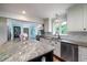 Open concept kitchen with granite island, white cabinets, and stainless steel appliances at 375 Seewee Cir, Mount Pleasant, SC 29464