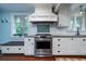 Well-lit kitchen featuring stainless steel stove, white cabinets, and granite countertops at 375 Seewee Cir, Mount Pleasant, SC 29464