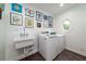 Laundry room with laundry sink and white washer and dryer with artwork on the wall at 375 Seewee Cir, Mount Pleasant, SC 29464