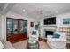 Bright living room with fireplace, and wood doors leading to the outdoors at 375 Seewee Cir, Mount Pleasant, SC 29464