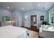 Light filled main bedroom featuring hardwood floors, white trim, sitting area, and blue accent wall at 375 Seewee Cir, Mount Pleasant, SC 29464