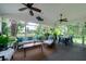 Cozy screened-in porch with ample seating, ceiling fans and views of the backyard at 375 Seewee Cir, Mount Pleasant, SC 29464