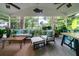 Inviting screened-in porch with ample seating, ceiling fans and views of the backyard at 375 Seewee Cir, Mount Pleasant, SC 29464