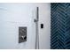 Shower controls and wall mounted shower head with blue herringbone tile accent wall at 375 Seewee Cir, Mount Pleasant, SC 29464