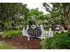 Inviting entrance to the Hobcaw Yacht Club with lush landscaping and a charming white fence at 375 Seewee Cir, Mount Pleasant, SC 29464