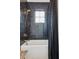 Bathroom with black tile, white tub, brass shower head, and black and white curtain at 3871 Sawyers Island Dr, Mount Pleasant, SC 29466