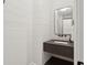 Modern powder room featuring a floating vanity with dark countertop and horizontal shiplap walls at 3871 Sawyers Island Dr, Mount Pleasant, SC 29466