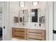 Bathroom with shiplap walls, double vanity with wood cabinets, and modern fixtures at 3871 Sawyers Island Dr, Mount Pleasant, SC 29466
