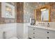 Stylish powder room featuring designer wallpaper, marble vanity, and elegant fixtures at 3871 Sawyers Island Dr, Mount Pleasant, SC 29466