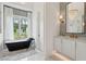 Spacious bathroom with tub, vanity, and chandelier at 3871 Sawyers Island Dr, Mount Pleasant, SC 29466