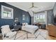 Bedroom with hardwood floors, starry wallpaper, blue accent wall, white area rug, and ceiling fan at 3871 Sawyers Island Dr, Mount Pleasant, SC 29466