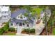 Stunning elevated home with a modern coastal design, lush landscaping, and a spacious driveway at 3871 Sawyers Island Dr, Mount Pleasant, SC 29466