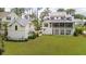 Stunning exterior elevation of a coastal-style home with well-manicured lawn and mature trees at 3871 Sawyers Island Dr, Mount Pleasant, SC 29466