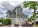 Beautiful home exterior with shingle siding and three-car garage, complemented by lush landscaping and a paver driveway at 3871 Sawyers Island Dr, Mount Pleasant, SC 29466
