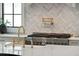 Close up of a modern kitchen featuring an island with a marble backsplash and gold pot filler at 3871 Sawyers Island Dr, Mount Pleasant, SC 29466