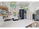 Bright kitchen with spacious countertops, stainless steel refrigerator, and elegant chandeliers at 3871 Sawyers Island Dr, Mount Pleasant, SC 29466
