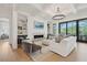 Elegant living room with coffered ceiling, fireplace, built-in shelving and access to the outdoors at 3871 Sawyers Island Dr, Mount Pleasant, SC 29466
