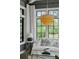 Cozy living room featuring a white sofa, crystal chandelier, and large windows at 3871 Sawyers Island Dr, Mount Pleasant, SC 29466