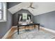 Home office with dark gray walls, vaulted ceiling, wood floors, and a decorative rug at 3871 Sawyers Island Dr, Mount Pleasant, SC 29466