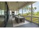 Screened-in porch featuring a dining area and fireplace with comfortable seating at 3871 Sawyers Island Dr, Mount Pleasant, SC 29466