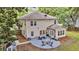 Aerial view of the backyard with a patio, firepit area, mature trees, and manicured lawn at 3873 Hanoverian Dr, Mount Pleasant, SC 29429