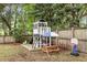 Backyard with playhouse, picnic table, basketball hoop, and fenced yard at 3873 Hanoverian Dr, Mount Pleasant, SC 29429