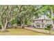 Spacious backyard with mature trees, a hammock, and a view of the home's exterior at 3873 Hanoverian Dr, Mount Pleasant, SC 29429