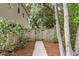 View of backyard wood fence and pathway leading into lush landscaping at 3873 Hanoverian Dr, Mount Pleasant, SC 29429