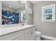 Well-lit bathroom featuring a white vanity and a bathtub with a colorful shower curtain at 3873 Hanoverian Dr, Mount Pleasant, SC 29429