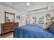 Tranquil bedroom with a blue comforter, ensuite bathroom, and natural light from the windows at 3873 Hanoverian Dr, Mount Pleasant, SC 29429