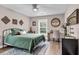 Cozy bedroom featuring a metal frame bed, wood flooring, and lots of natural light at 3873 Hanoverian Dr, Mount Pleasant, SC 29429