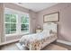Charming bedroom features a twin bed with floral bedding and lots of natural light at 3873 Hanoverian Dr, Mount Pleasant, SC 29429
