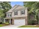 Two-story home with a stone accent front, white garage door, and neutral siding at 3873 Hanoverian Dr, Mount Pleasant, SC 29429