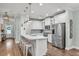 Modern white kitchen featuring stainless steel appliances and a center island with seating at 3873 Hanoverian Dr, Mount Pleasant, SC 29429