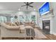Cozy living room featuring a fireplace, large sectional sofa, and a ceiling fan at 3873 Hanoverian Dr, Mount Pleasant, SC 29429