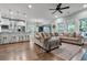 Open living room with hardwood floors, large windows, and modern furniture at 3873 Hanoverian Dr, Mount Pleasant, SC 29429