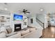 Inviting living room featuring a cozy fireplace, built-in shelving, and a modern ceiling fan at 3873 Hanoverian Dr, Mount Pleasant, SC 29429