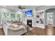 Cozy living room with fireplace, custom shelving, and lots of natural light at 3873 Hanoverian Dr, Mount Pleasant, SC 29429