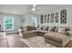 Comfortable living room with a large sectional couch, decorative wall art, and hardwood floors at 3873 Hanoverian Dr, Mount Pleasant, SC 29429
