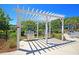 Outdoor grilling area with two stainless steel grills under a white pergola near pool at 3873 Hanoverian Dr, Mount Pleasant, SC 29429