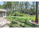Expansive backyard featuring a lush green lawn, white fencing, and mature trees at 404 Bowstring Dr, Huger, SC 29450