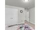 Bedroom with view of a pair of doors, wall clock, and floral bedding at 404 Bowstring Dr, Huger, SC 29450