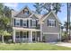 Beautiful two-story home featuring a classic design, well-kept lawn, and attached garage at 404 Bowstring Dr, Huger, SC 29450