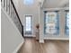 Bright foyer with hardwood floors, staircase, and windows offering ample natural light and a welcoming entrance at 404 Bowstring Dr, Huger, SC 29450